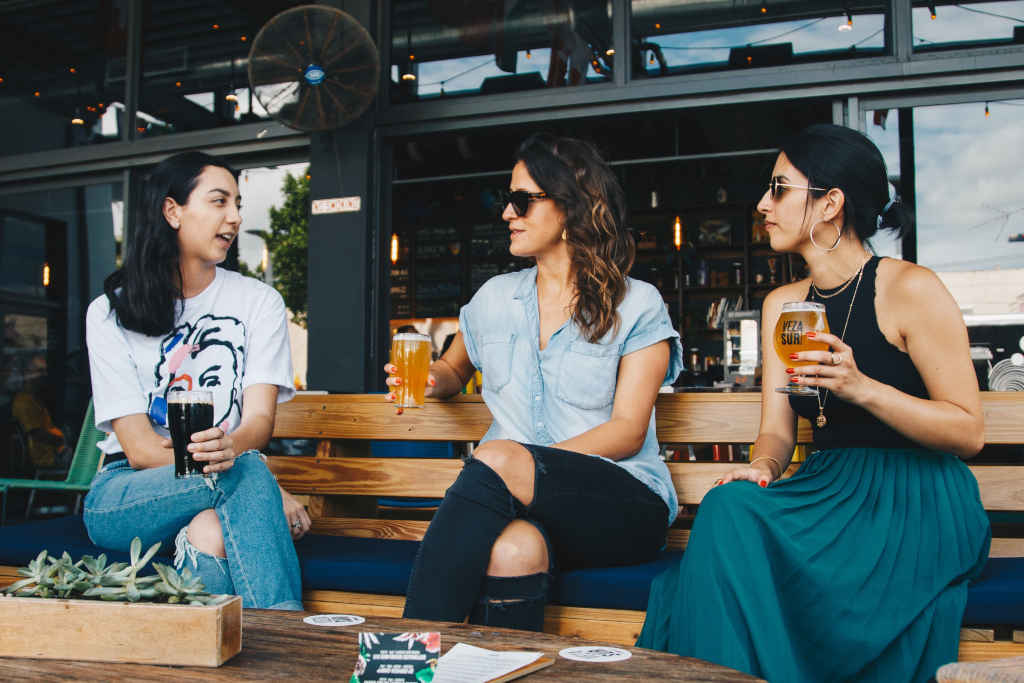 Three women holding clear glasses - Photo by ELEVATE on pexels