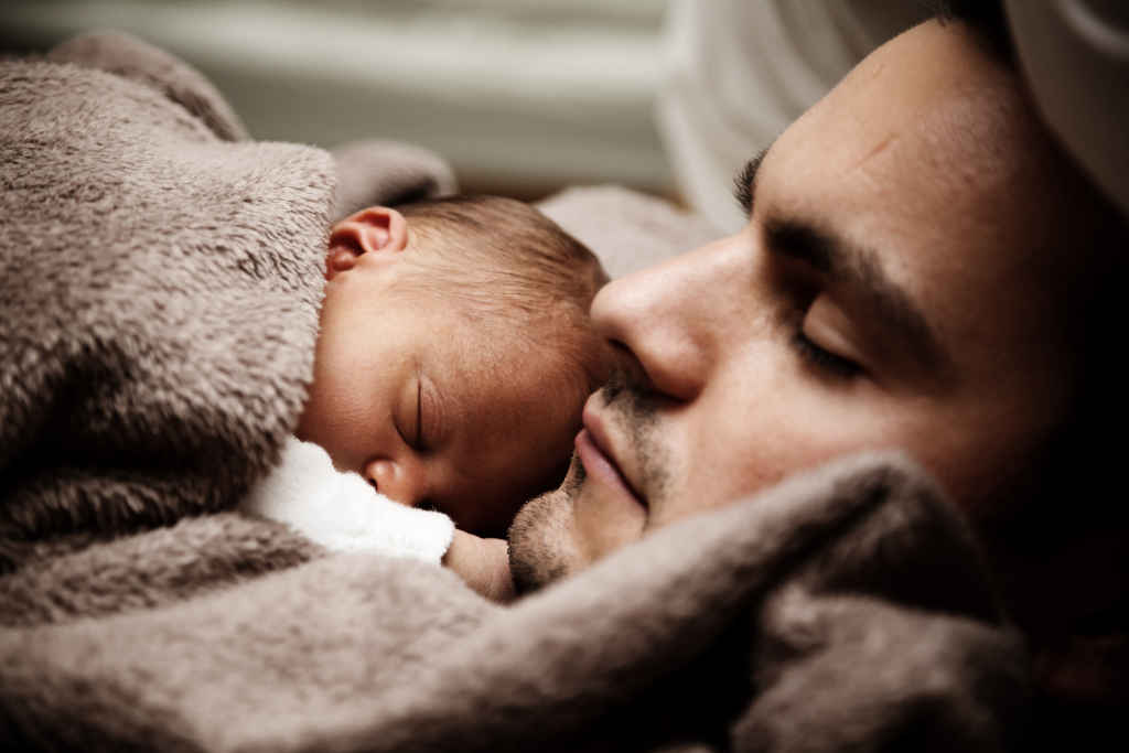 Man holding baby and sleeping - Photo by pixabay on pexels